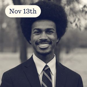 Young man with an afro wearing a suit and tie, smiling outdoors with a date overlay.