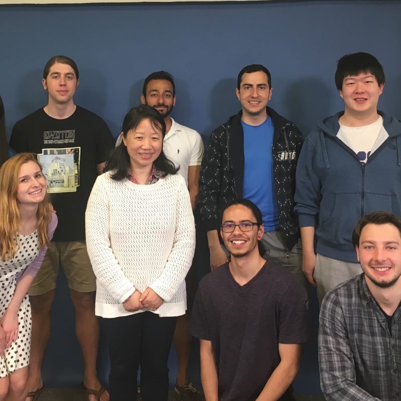 Students standing with professor