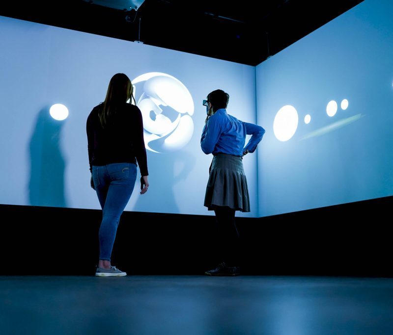 Two people using VR goggles
